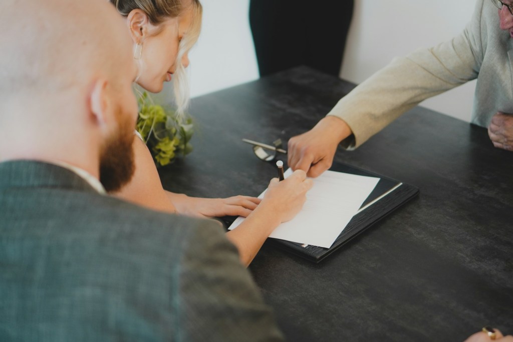 Buyers signing property documents